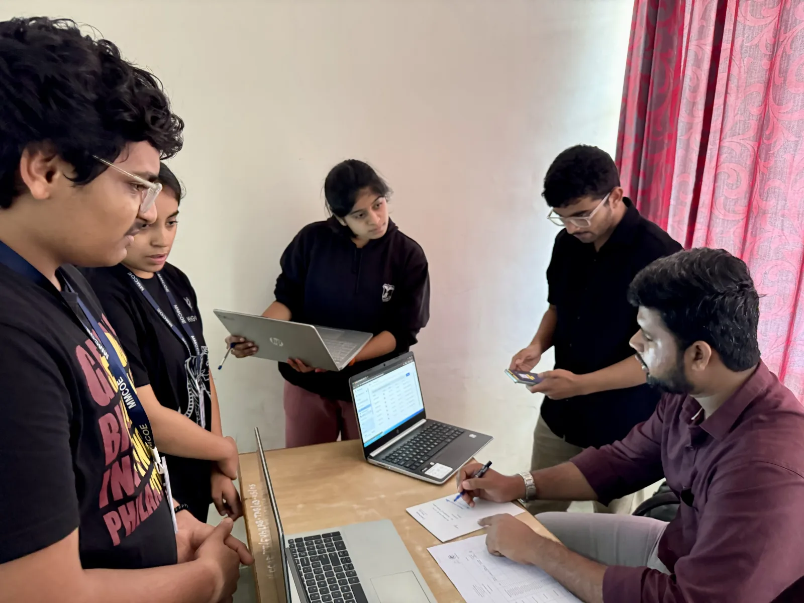 Website Vikreta team reviewing a client project with students